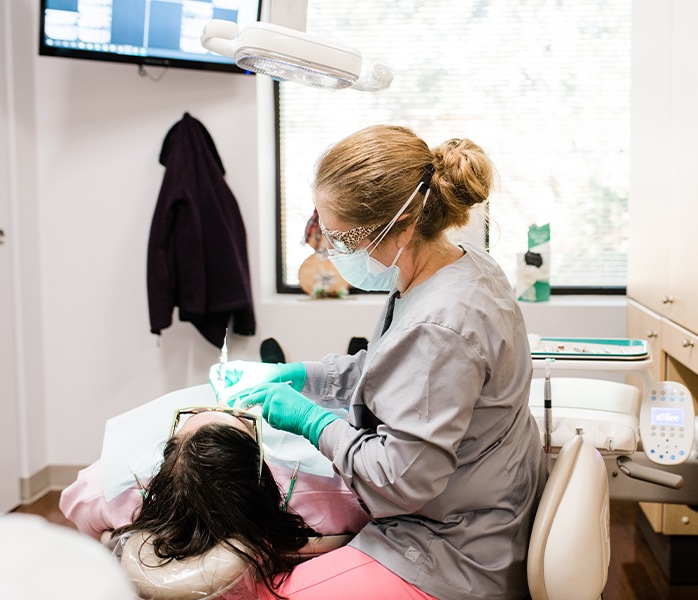 Dental team member working with dental patient during first dental visit