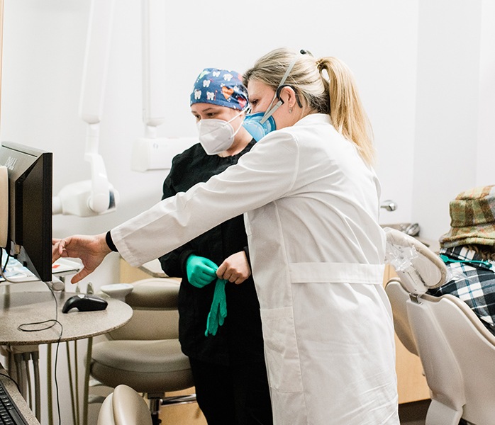 Dental team members reviewing dental patient information