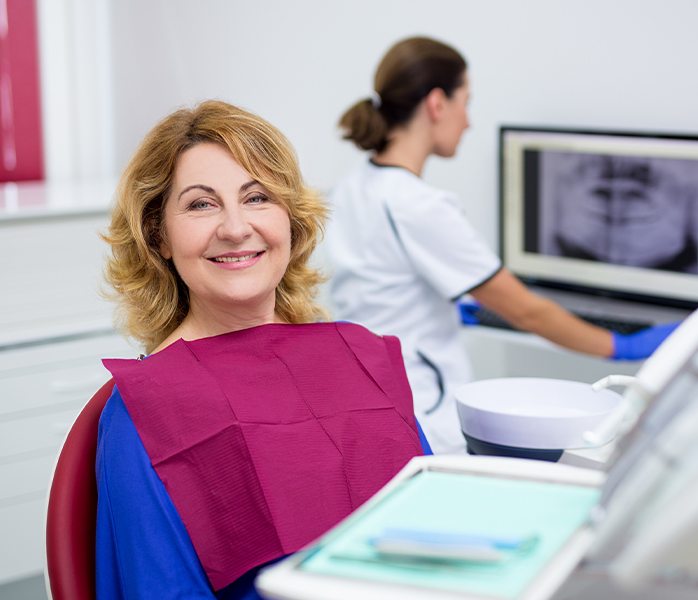 Woman smiling during all on four dental treatment