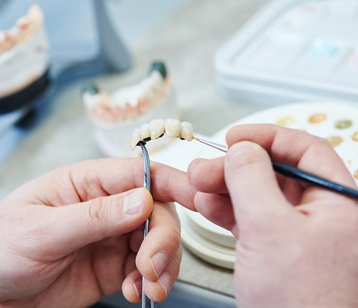 A worker making a dental bridge in Millersville