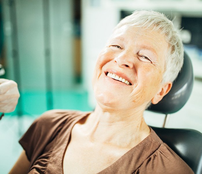 A woman happy with her dental bridge from Millersville