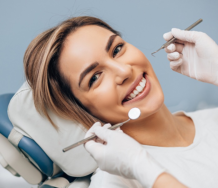 Woman smiling during dental checkups and teeth cleanings