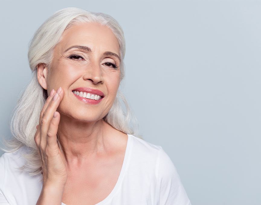 Woman showing off her new dentures