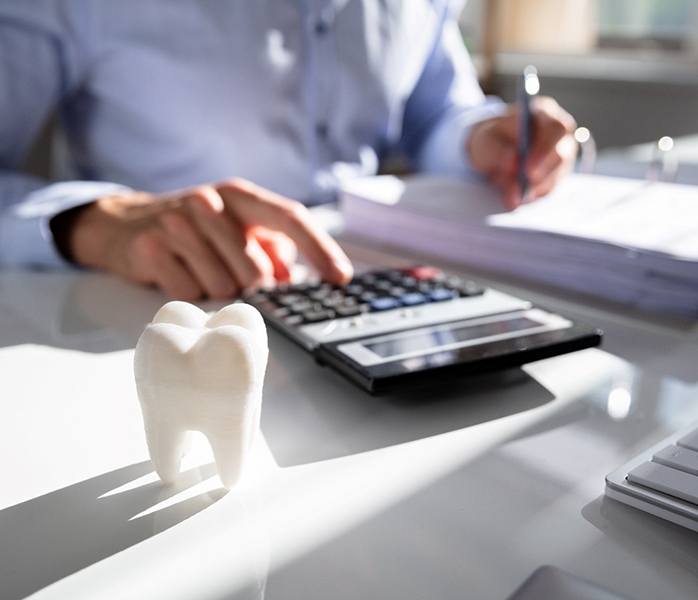 person calculating cost of dentures in Millersville