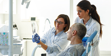  dentist and patient discussing the cost of dental emergencies