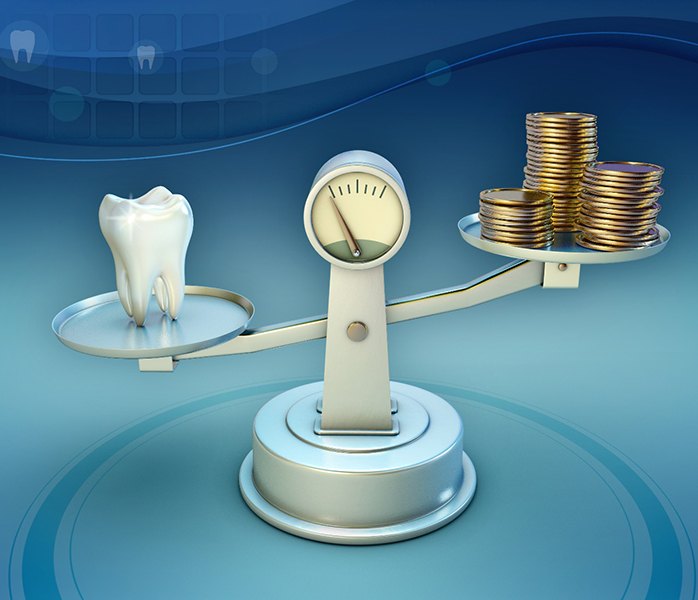 Tooth and coins on a balance scale