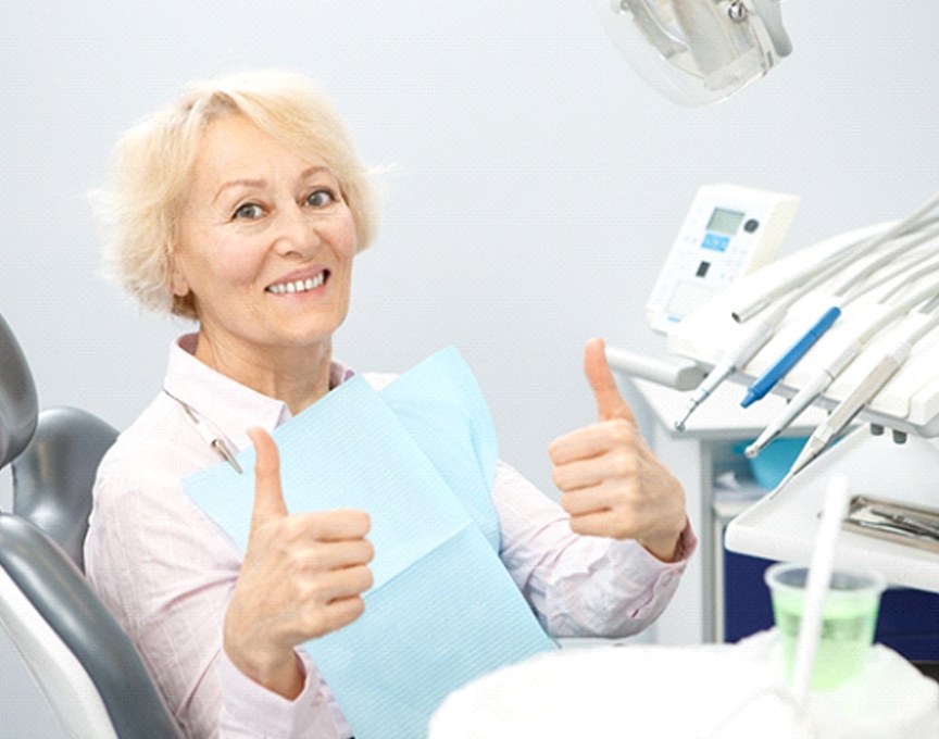 Senior patient giving thumbs up for implant dentures in Millersville