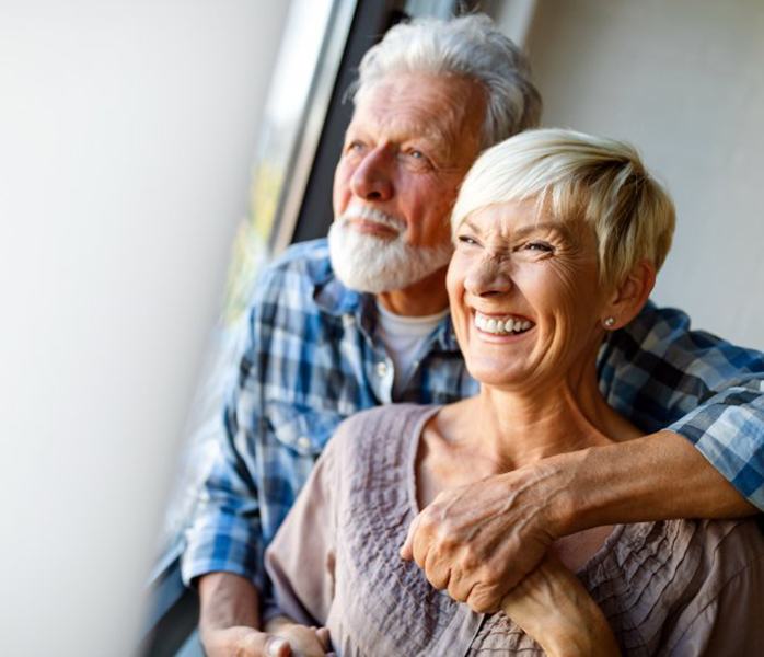 An older couple with dental implants in Millersville smiling