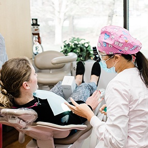 Doctor Tran talking to dental patient