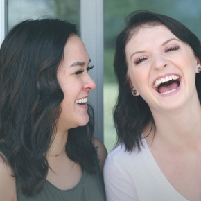 Two women laughing with healthy smiles after preventive dentistry