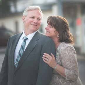 Man and woman holding each other in formal clothing