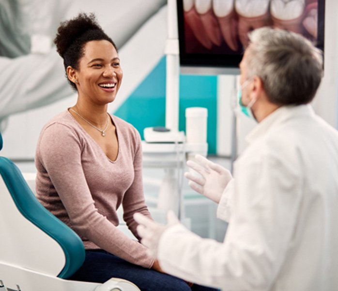 dentist talking to patient about dental insurance   