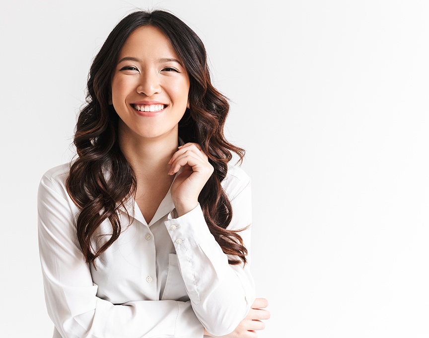 Woman with flawlessly aligned smile after Invisalign