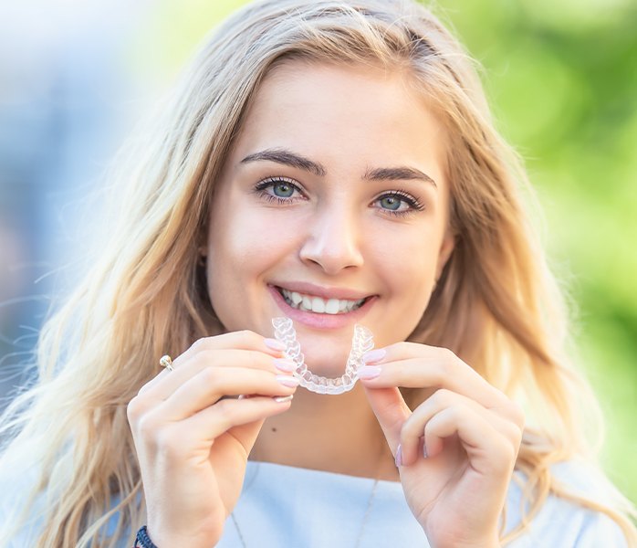 Woman placing an Invisalign tray