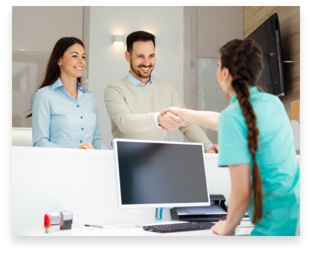 receptionist shaking hands with patient