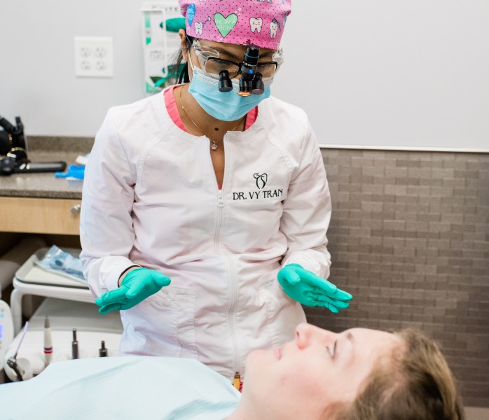 Doctor Tran laughing with dental patient