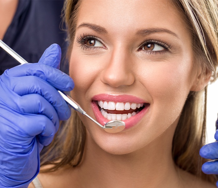 Woman receiving dental checkups and teeth cleanings
