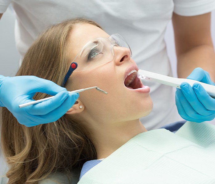 Dentist using intraoral camera to capture smile images