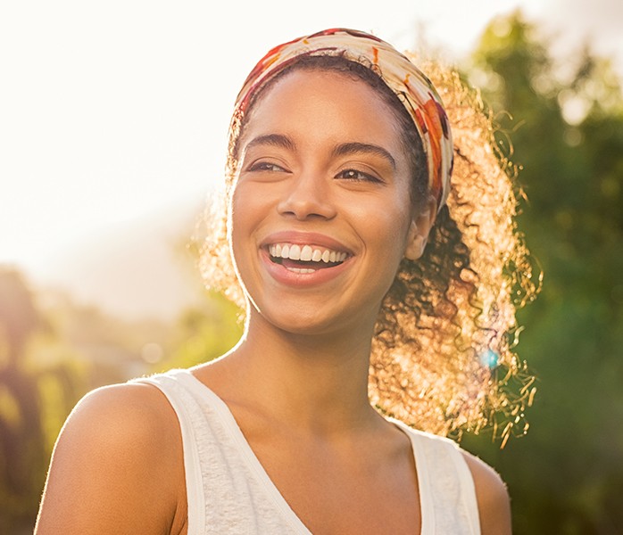 Woman with flawless smile after tooth colored fillings