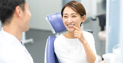 a patient smiling after undergoing teeth whitening