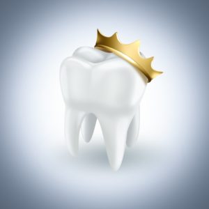 white tooth golden crown on top