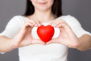 woman holding love heart