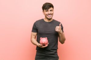 happy man holding piggy bank