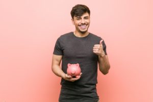 happy man holding piggy bank 