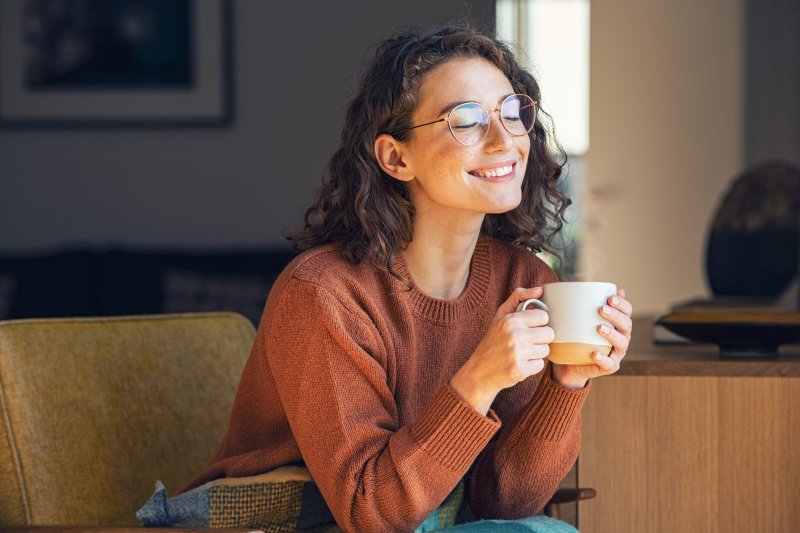 A woman enjoying tea with sugar substitutes