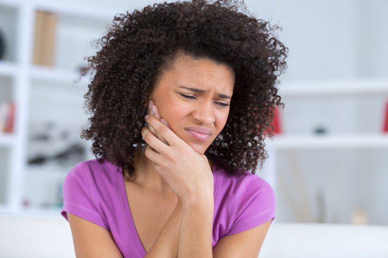 A woman suffering from jaw pain from TMD