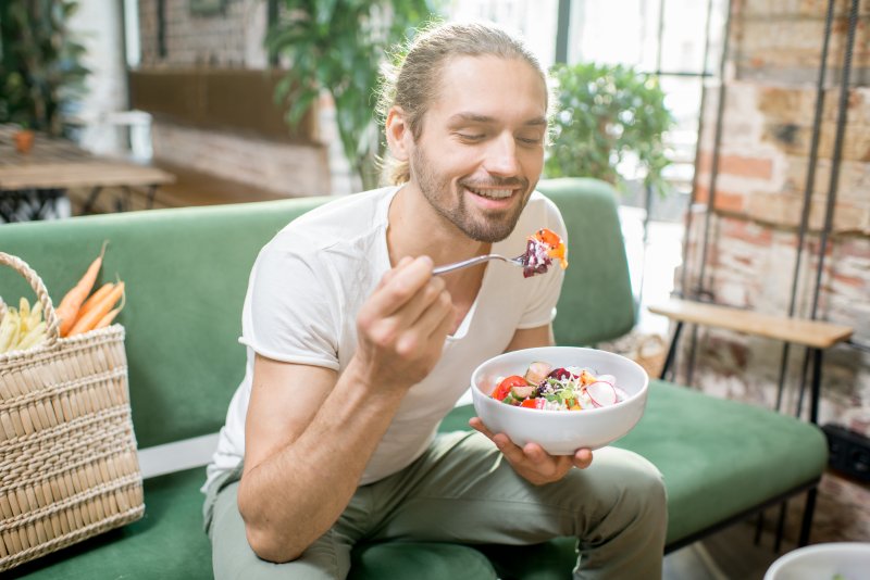 Patient eating food to help his TMJ disorder