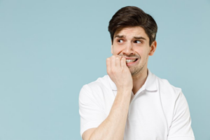Nervous man biting his fingers